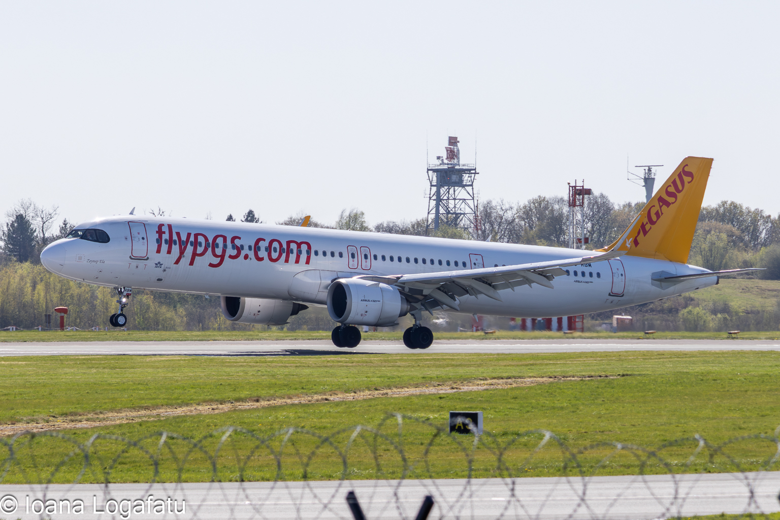 Airplane taking off from runway at sunny airport